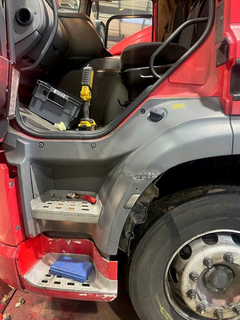 Red truck closeup having bodywork repairs by burton commercialsl